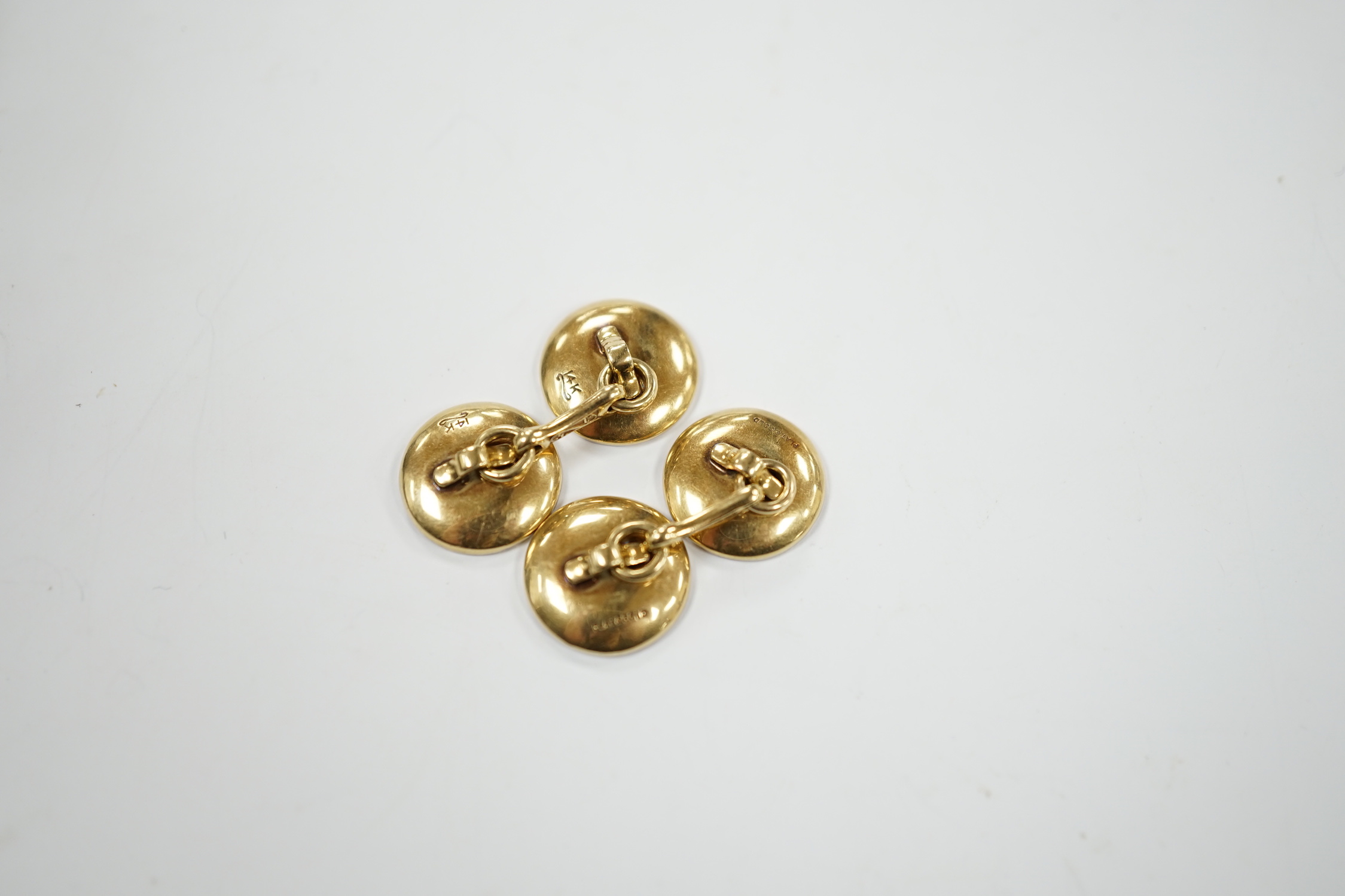 A pair of 14k yellow metal, mother of pearl and diamond chip set circular cufflinks, 12mm, gross weight 6.4 grams.